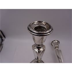 Pair of early 20th century silver mounted candlesticks, of tapering fluted form, upon a weighted stepped domed square base with canted corners, hallmarked Henry Williamson Ltd, Birmingham 1915, H26cm
