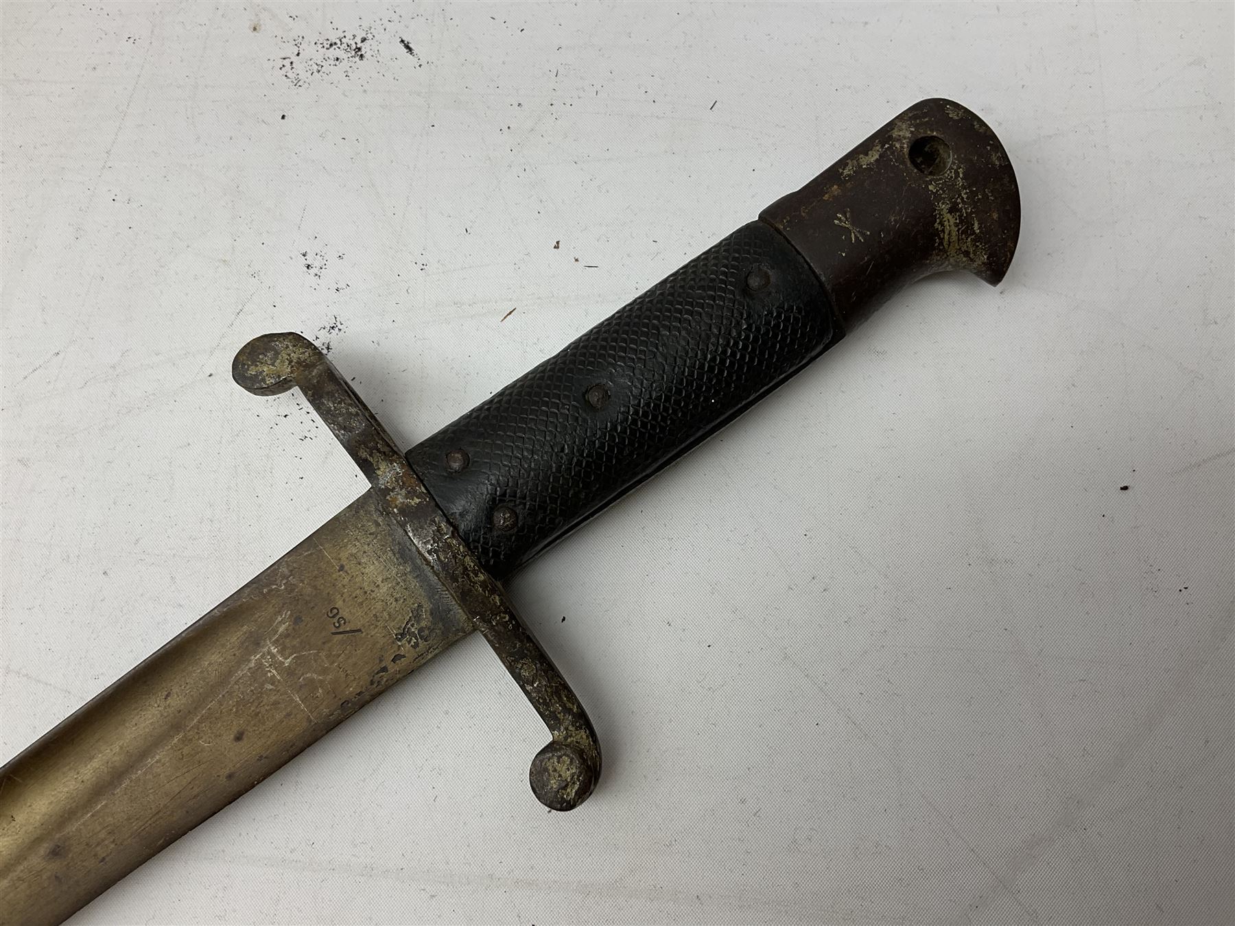 French Model 1866 sabre bayonet with 57cm fullered steel curving blade; in steel scabbard L71cm overall; another Model 1866 sabre bayonet lacking scabbard; and British Pattern 1856 sword bayonet (no scabbard) (3)