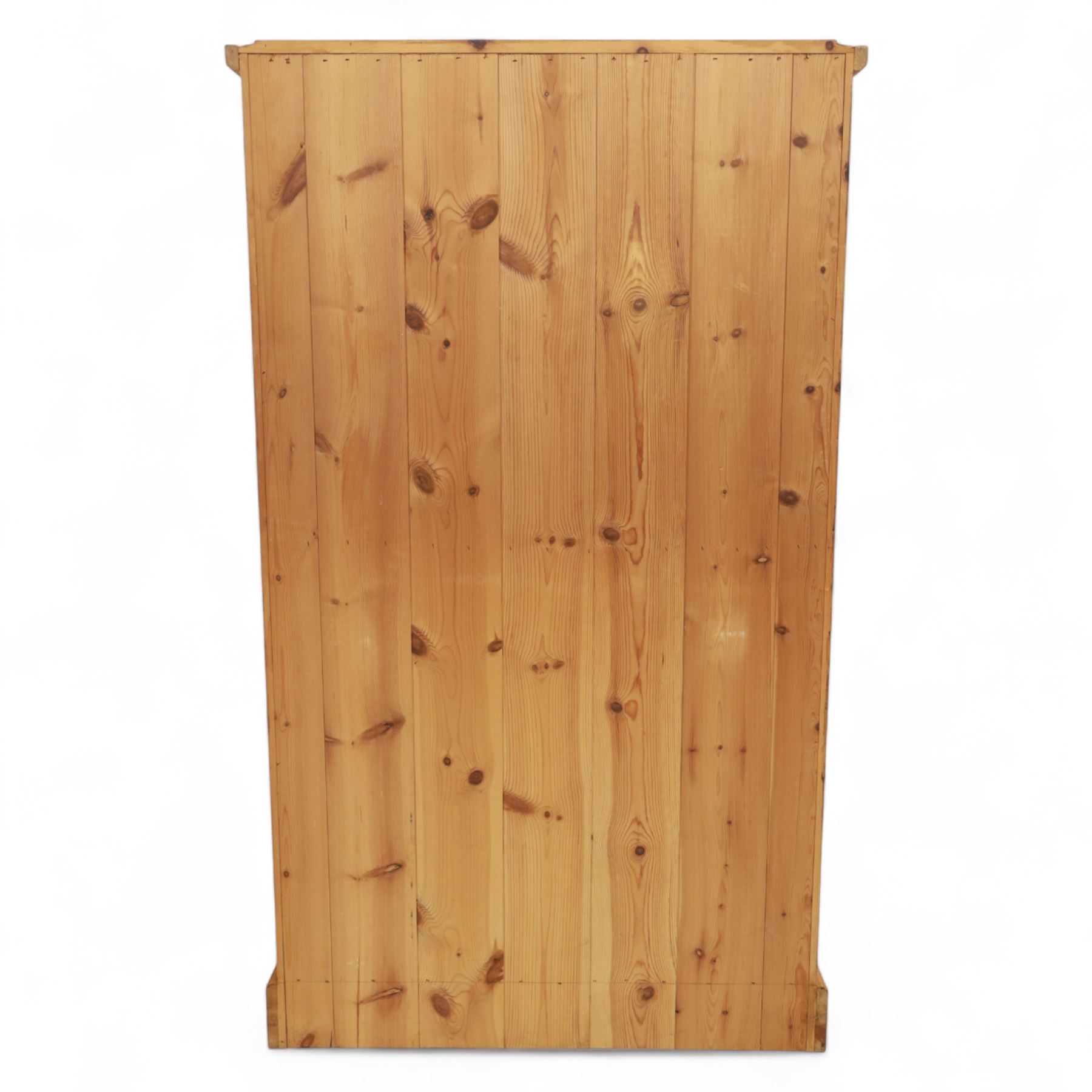 Modern stripped pine two-door wardrobe, the fielded panel doors with turned knob handles, opening to a double rail hanging interior, beneath a stepped cornice and raised on plinth base