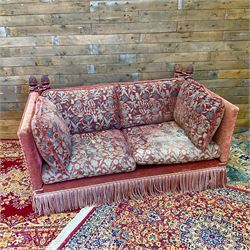 Knole type drop arm sofa with cushions in a traditional patterned upholstery,