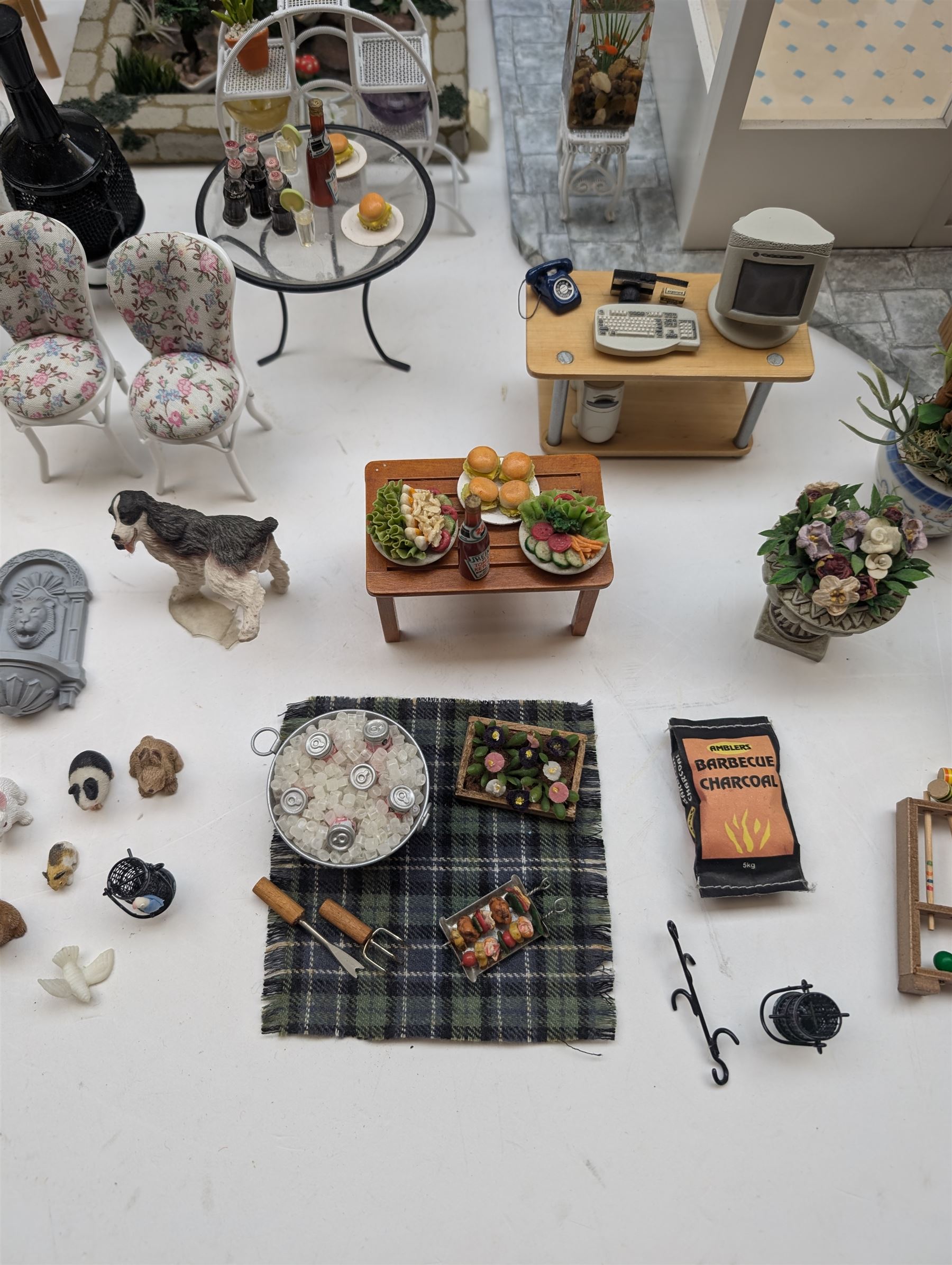 1:12 scale dolls house conservatory and garden accessories, including white wooden glazed conservatory on a stone effect base, black and white metal garden seating, barbecue, plant shelves, parasol, barbeque accessories, large planters, rabbit hutch, animals, chimenea, etc