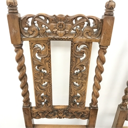 Set four Carolean style oak dining chairs, heavily carved and pierced cresting rail with floral detailing, cane work splat, upholstered seat, turned supports, carved stretcher, W50cm