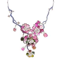 18ct white gold gemstone set floral jewellery suite, comprising necklace, pair of earrings and bracelet, each with tourmaline flower petals, round brilliant cut diamond centres and sapphire stems, stamped