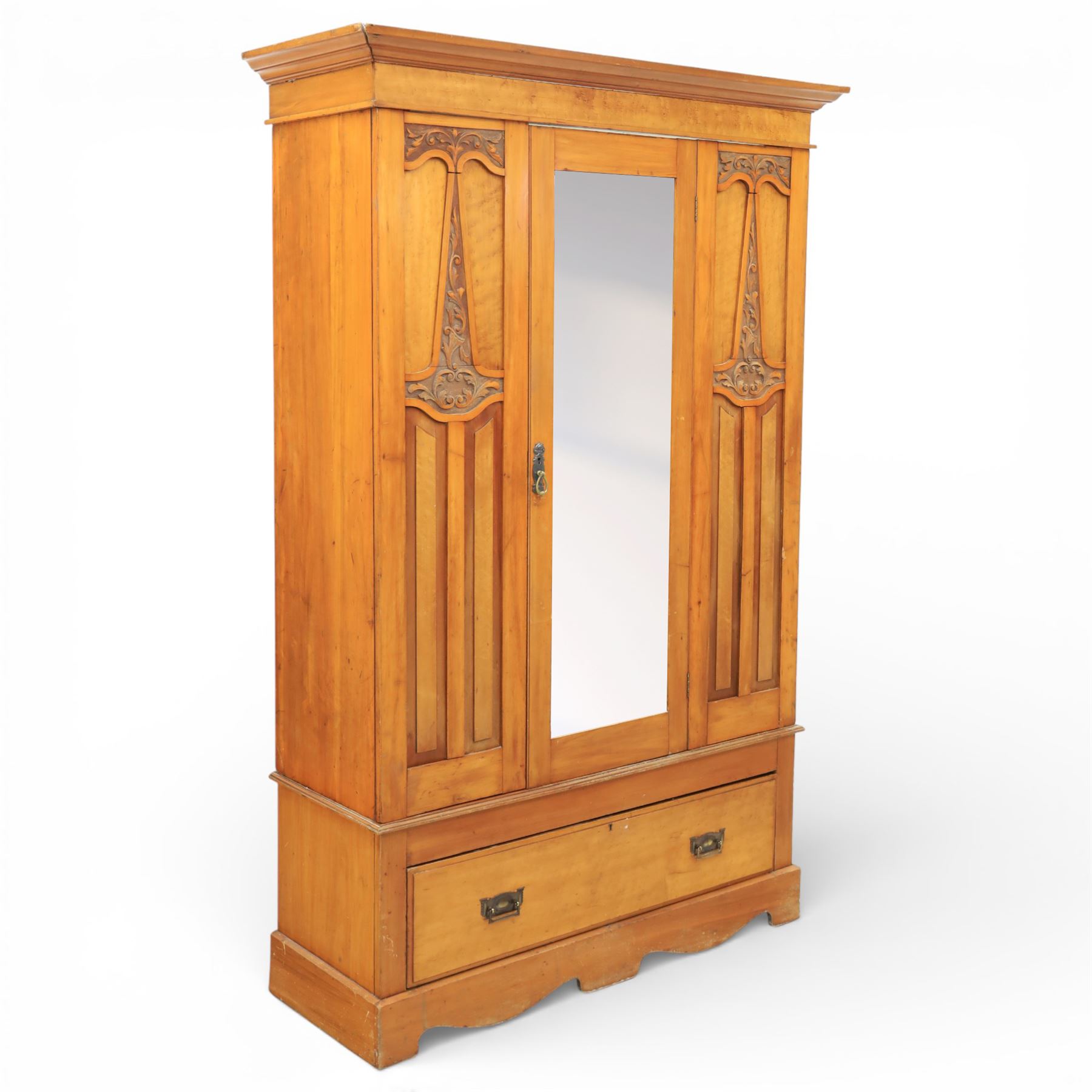 Early 20th century Art Nouveau walnut wardrobe, rectangular top over with single central mirrored panel door, the outer sides carved with sinuous foliate decoration and stylised stem motifs above recessed panels, single long drawer below with brass drop handles, on moulded plinth