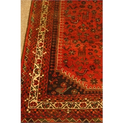  Persian Shiraz red ground rug, triple pole lozenge medallion, decorated all over with animal, bird and flower stylised motifs, 256cm x 195cm  