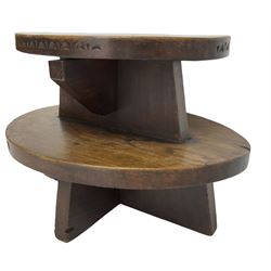 20th century figured elm occasional table, two oval tiers raised on cruciform base, the top tier carved with incised decoration 