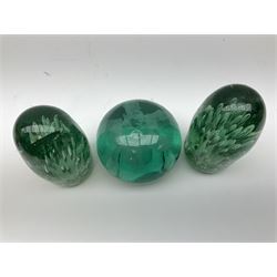Pair of Victorian green glass dump paperweights with air bubble inclusions, and another example with internal foil flower decoration, tallest example H16cm