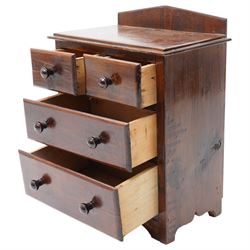 Miniature stained pine chest of two long and two short drawers above a shaped apron W28cm