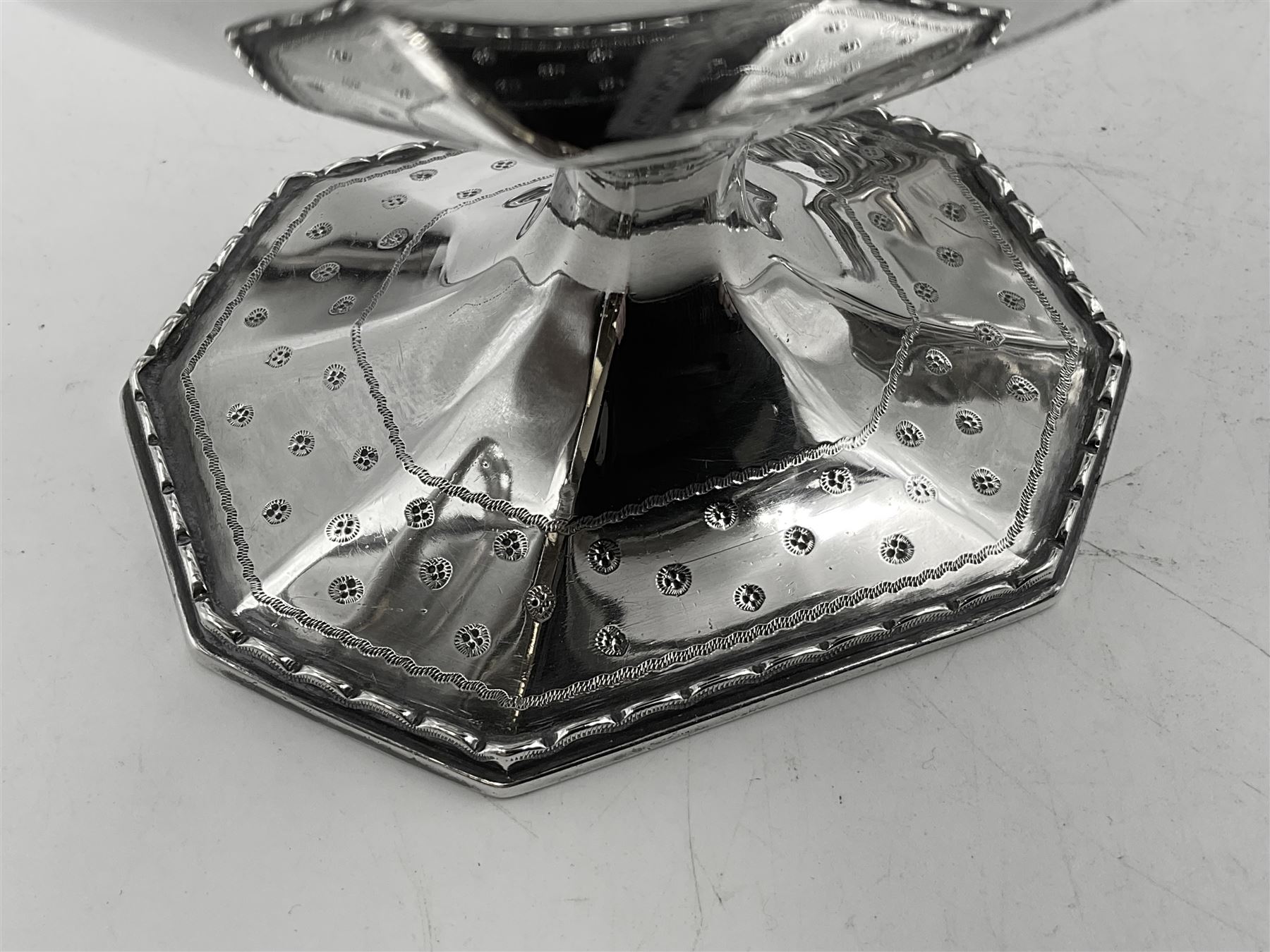 Victorian silver four piece tea service, comprising teapot, teapot stand, twin handled open sucrier and milk jug, each of octagonal form with foliate bud border and engraved decoration including crest to canted panels, and vacant panels, the teapot with ivory finial to the hinged cover and later wooden handle, hallmarked Edward Barnard & Sons Ltd, London1896, teapot including finial H15cm, milk jug including handle H16cm, teapot stand W11.5cm

This item has been registered for sale under Section 10 of the APHA Ivory Act