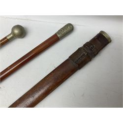 George V 1897 pattern Army Officer's sword by Henry Wilkinson Pall Mall London, the 82.5cm 'London Made' blade etched to both sides with Royal Crests and cyphers etc, pierced half-basket hilt with wire-bound fish skin grip and remains of leather knot strap; in leather covered field service scabbard L101cm overall; and two 14th Prince of Wales Own swagger sticks (3)