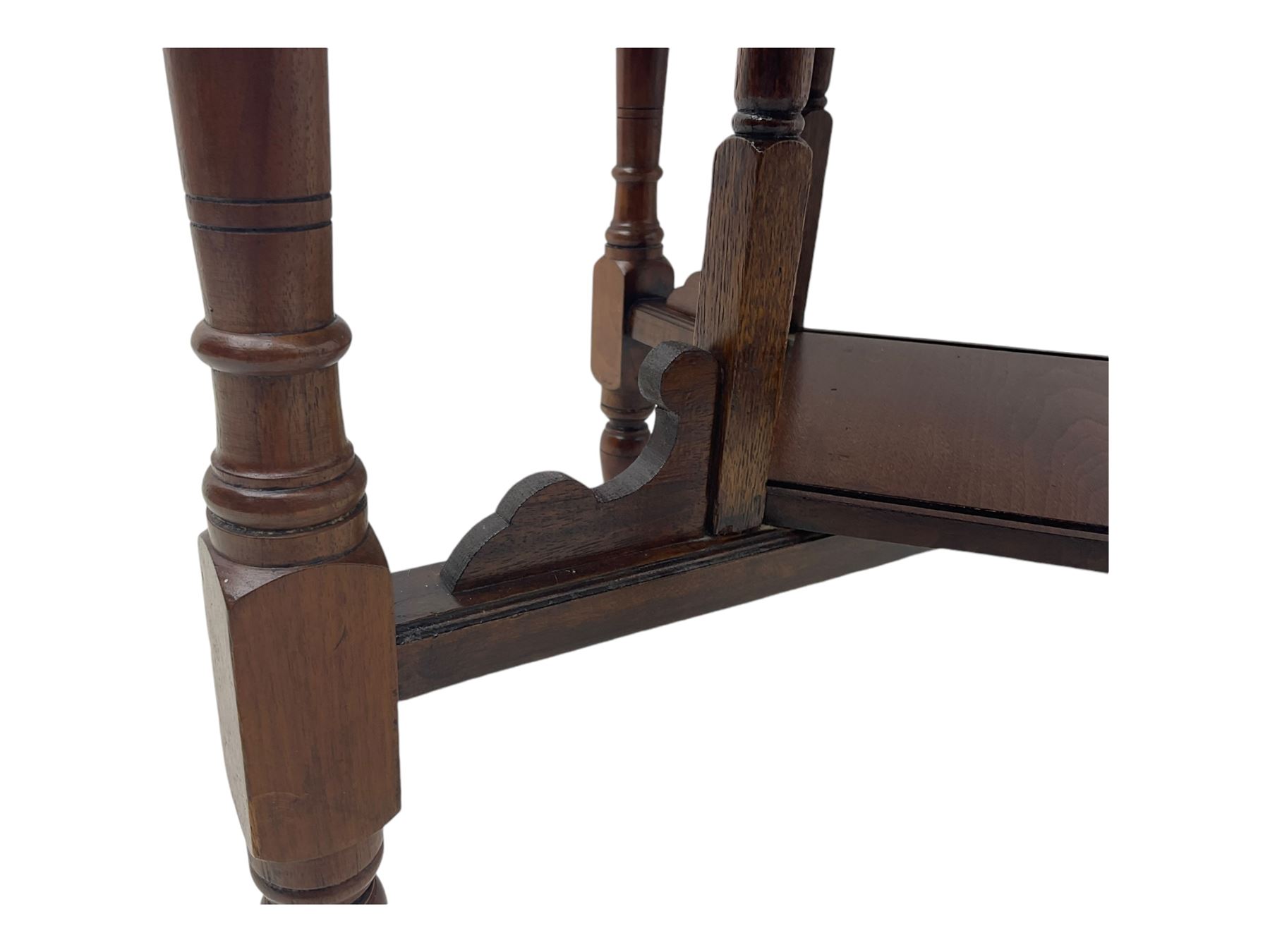 Victorian oak occasional table, octagonal top with bevelled edges, lower section fitted with a square undertier united by decorative shaped stretchers, on turned supports with castors