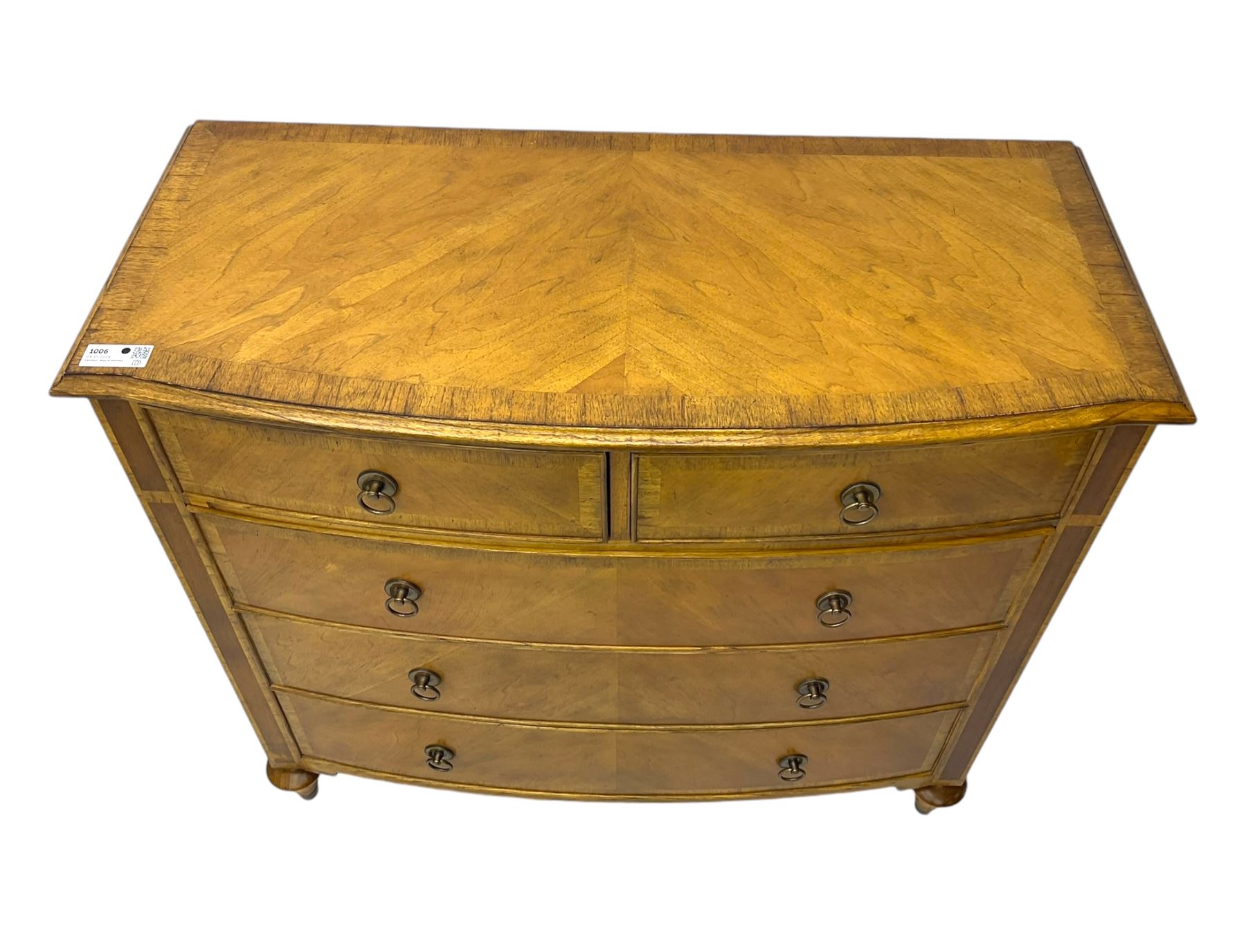 Frank Hudson - mid-20th century Mindi ash and burr walnut 'Spire' bow-fronted chest, featuring a crossbanded top over two short and three long cockbeaded drawers, raised on turned supports  