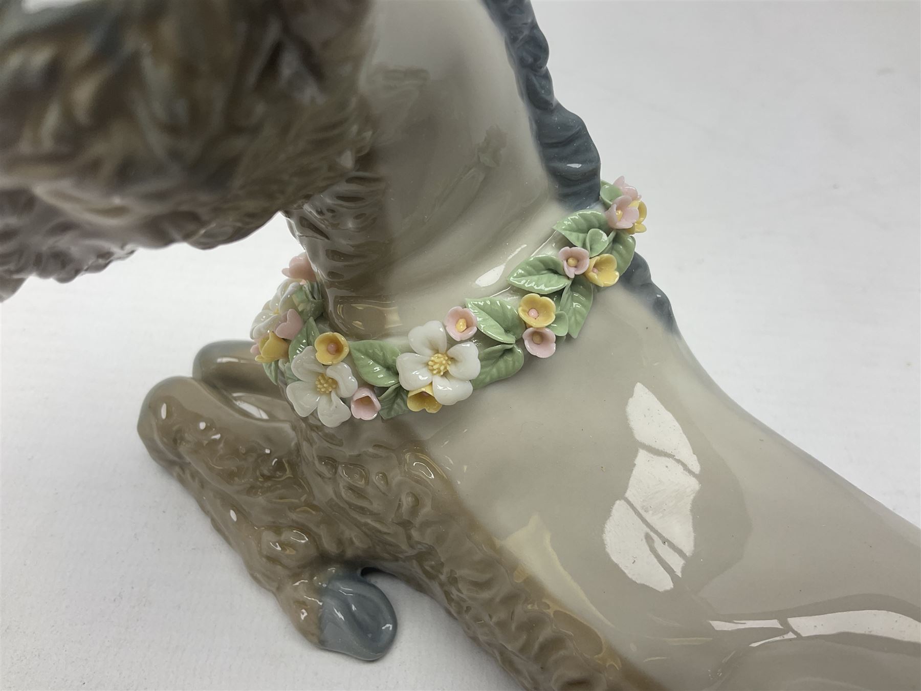 Lladro figures of animals, comprising Mini Lion no 5436, Beautiful Burro no 5683, Hawk Owl no 5422, Beagle Puppy Sitting no 1071, Duck Flying no 1264, Miniature Cat no 5308 and Small Papillon Dog no 4749, four with original boxes, largest example H14cm