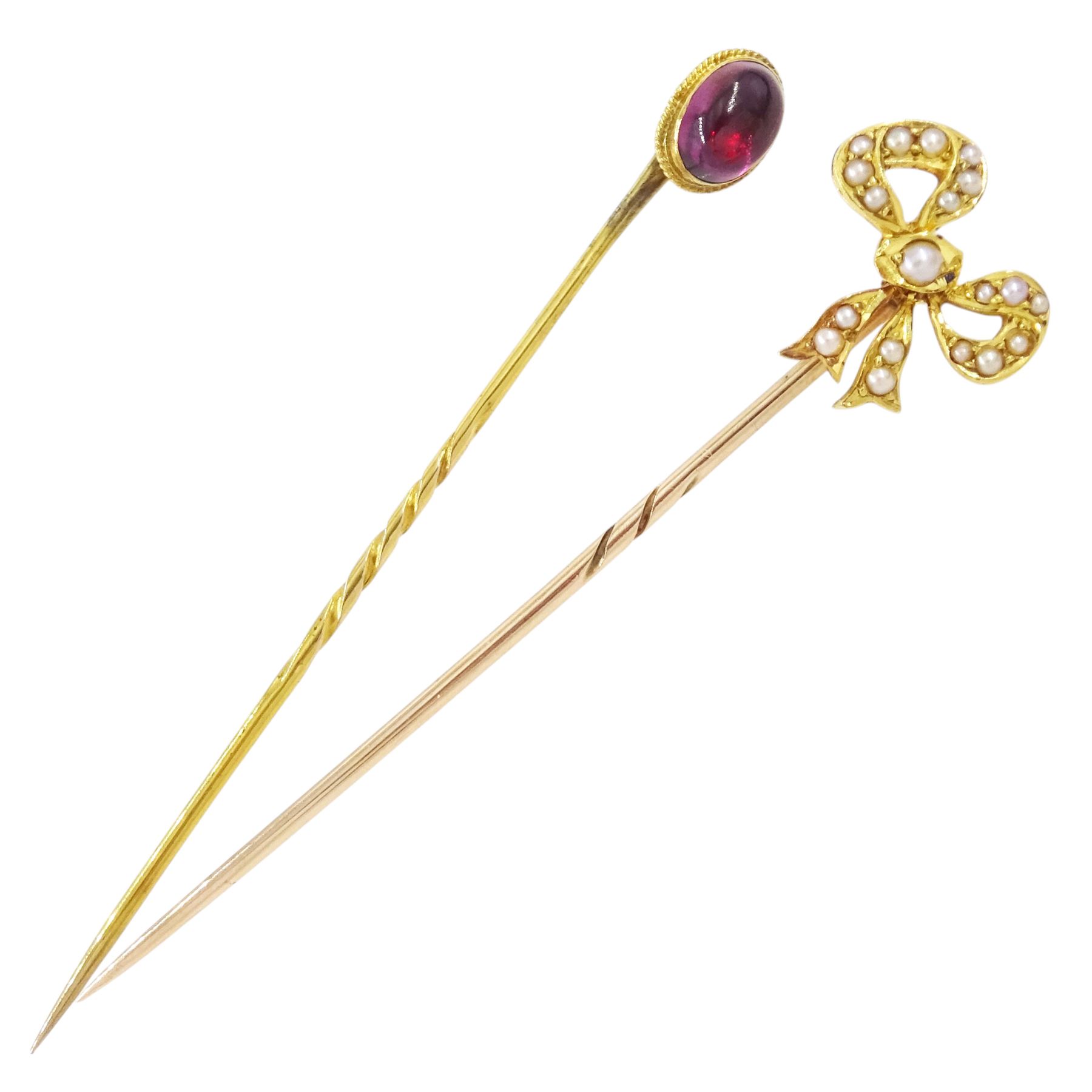 Two early 20th century gold stick pins, including a seed pearl set ribbon bow and cabochon garnet, one boxed