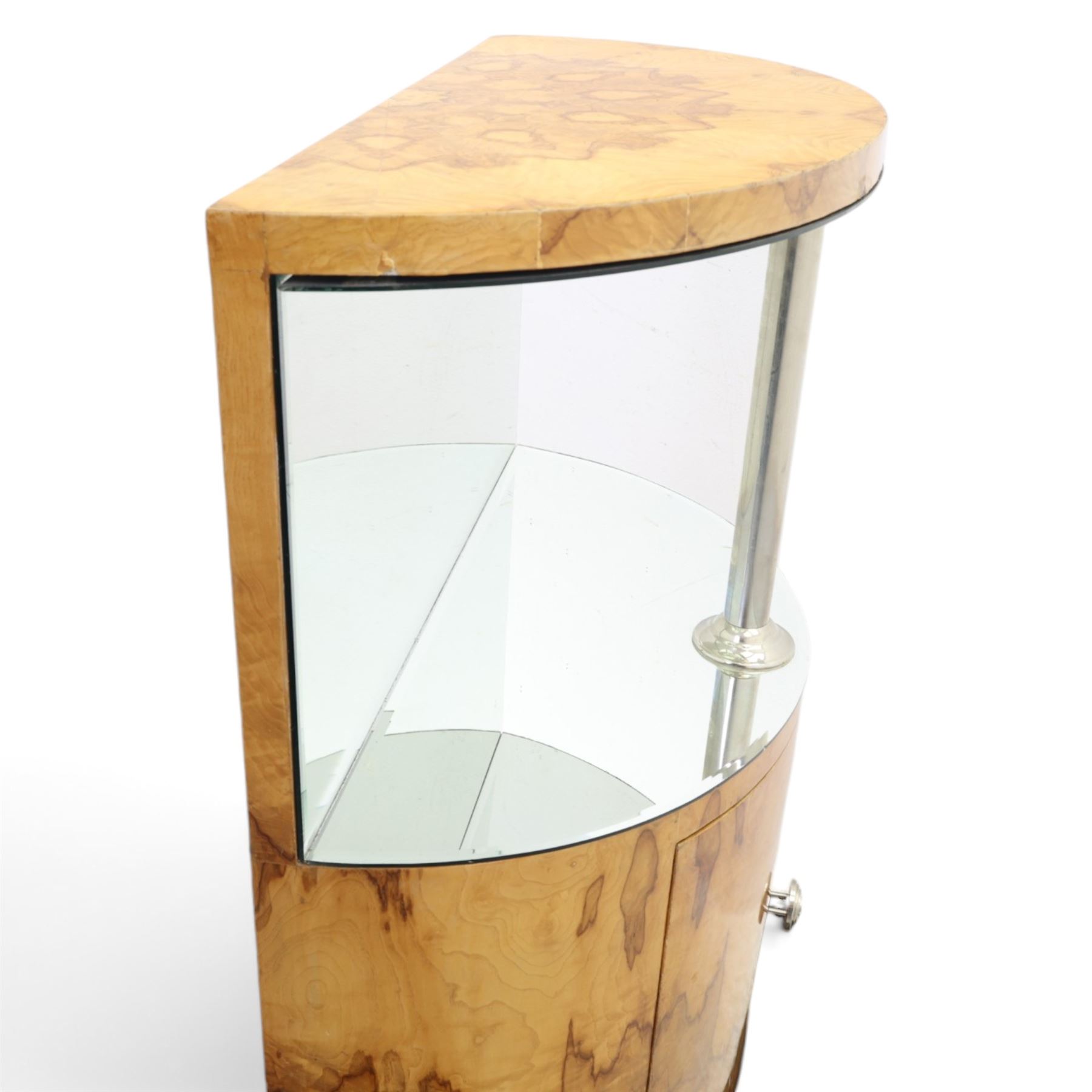 Art Deco figured walnut cocktail cabinet, demi-lune top above mirrored open compartment supported by chrome column, enclosed cupboard below with curved door, on shaped plinth base