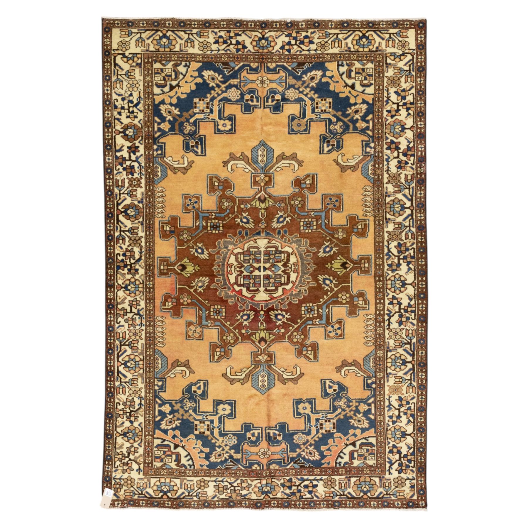 North West Persian Tafresh hand-knotted rug, pale apricot field with central stepped medallion enclosing stylized floral and angular motifs framed by indigo spandrels and multiple stylized floral borders, cotton fringe ends 