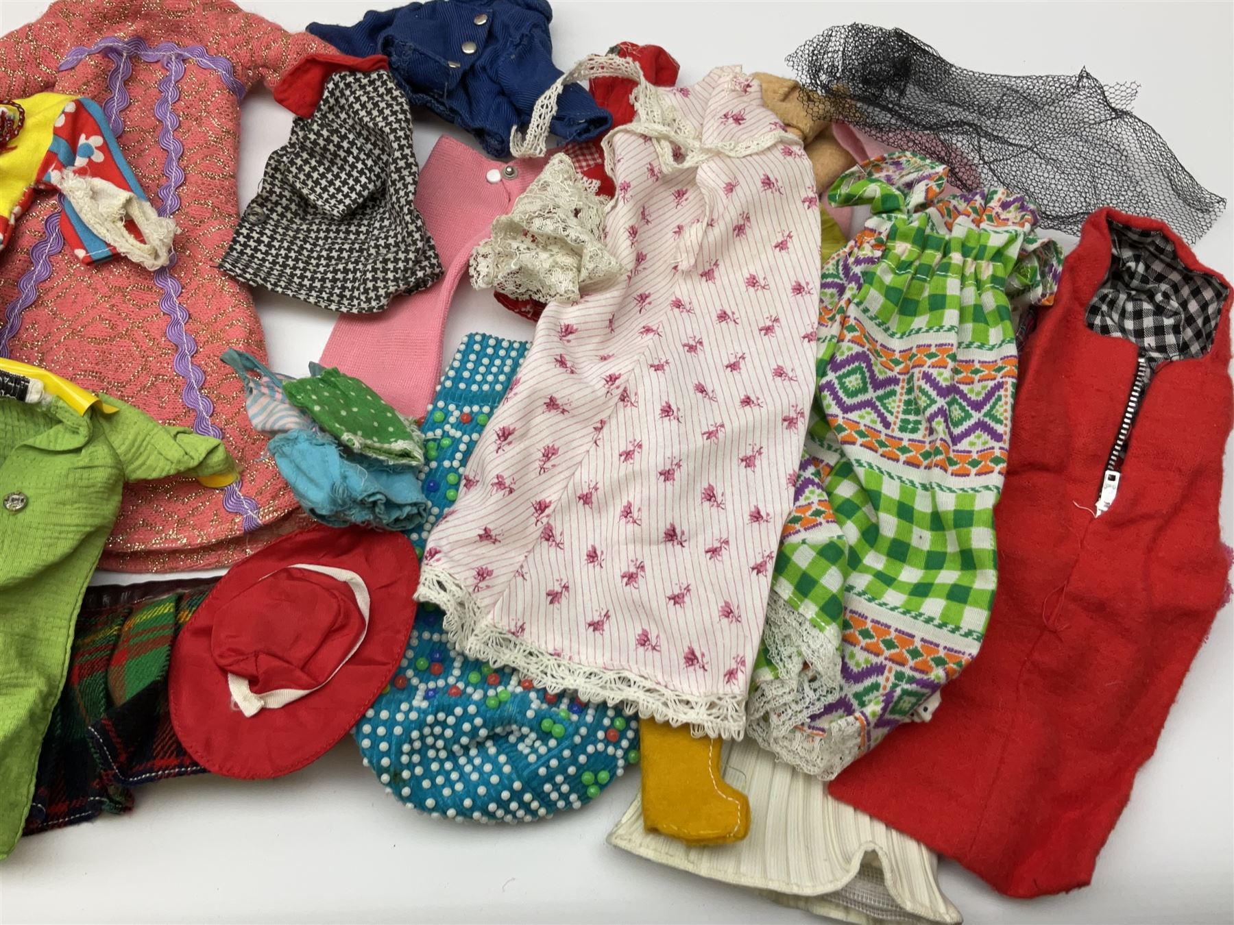 The World of Barbie Double Doll Case containing a quantity of assorted doll's clothing; together with two large and one small fashion dolls.