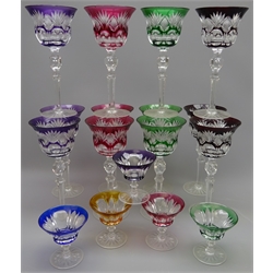  Set of twelve Bohemian Harlequin overlay flash cut claret glasses on tall faceted stems and a set of five matching liqueur glasses (17)    