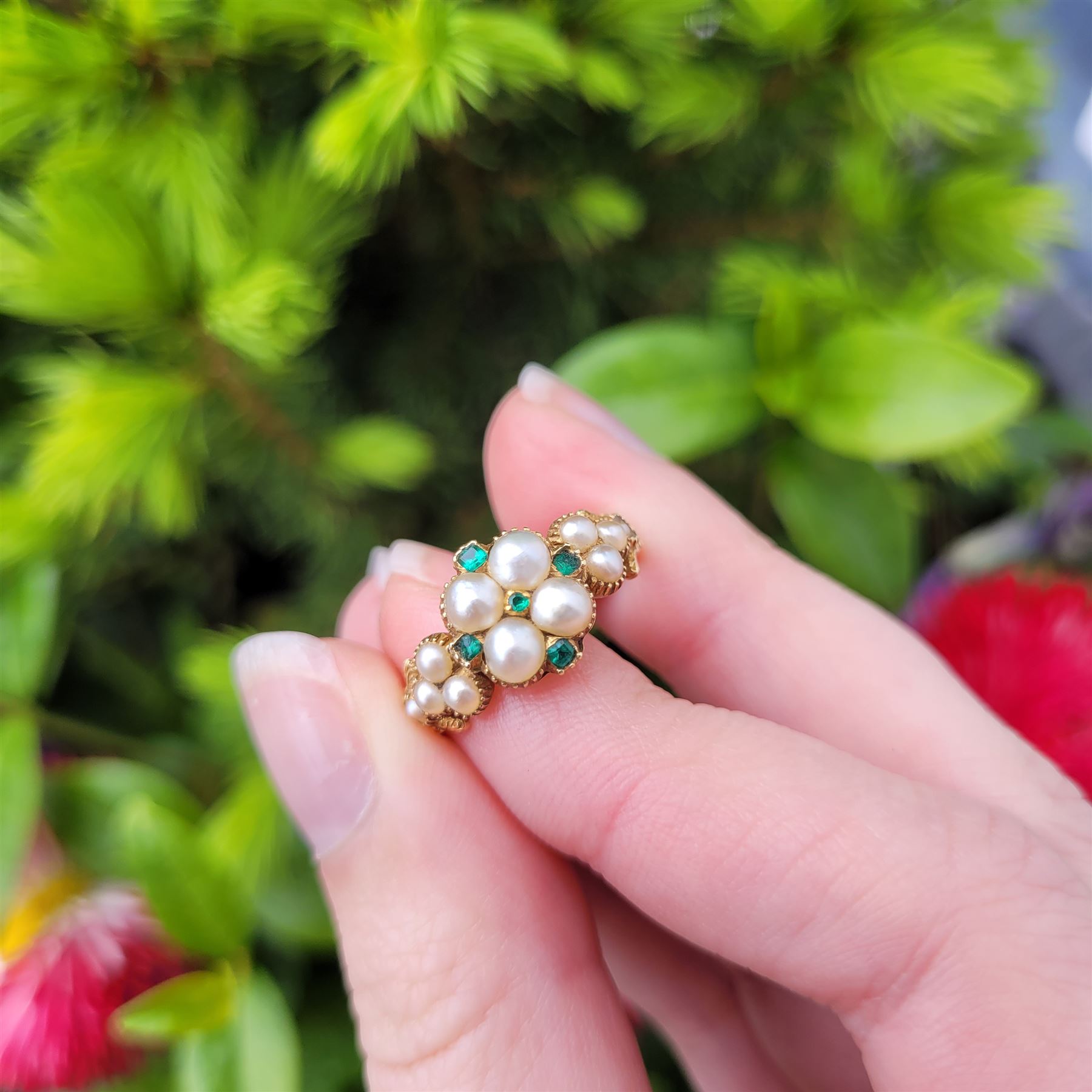 19th / early 20th century 18ct gold emerald and pearl flower head cluster ring, with pearl set shoulders and engraved foliate shank