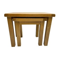 Light oak nest of two tables, rectangular top raised on square supports