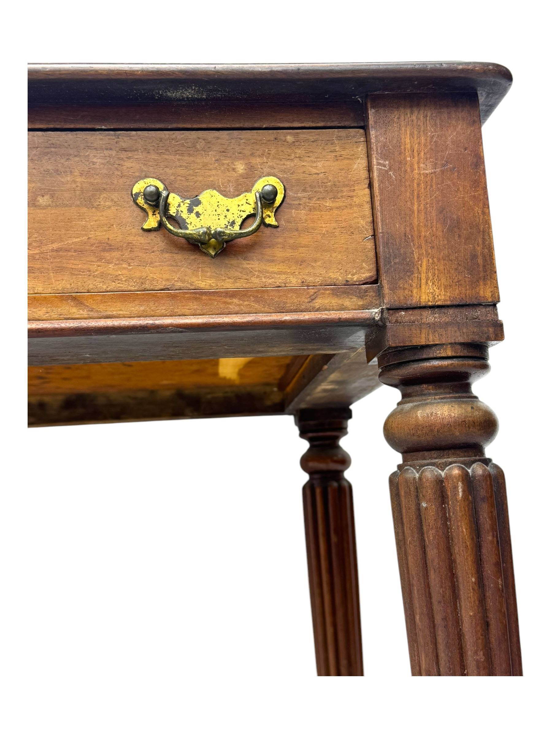 Early 19th century mahogany side table, moulded rectangular top over two drawers, on turned and reeded supports, brass cups and castors 