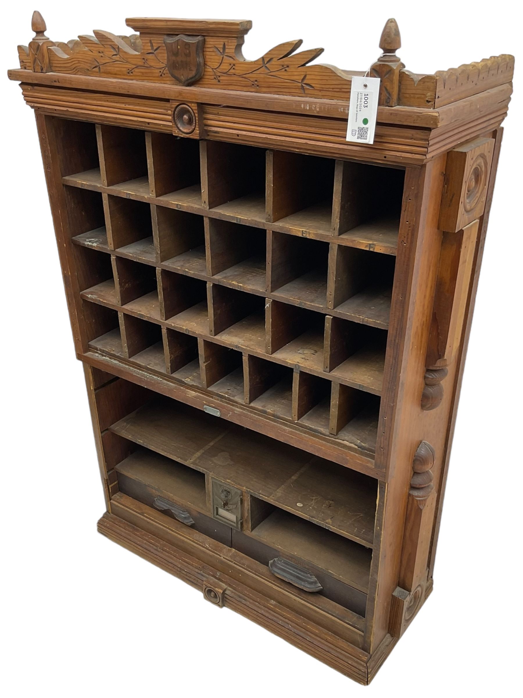 19th century stained pitch pine 'US Mail' pigeonhole unit, raised carved gallery with applied inscribed shield plaque, fitted with twenty five pigeon holes over shelves and correspondence drawers