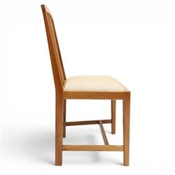 Knightman - set of nine cherrywood dining chairs, with fan splat backs and upholstered seats, raised on square legs joined by stretchers, comprising chairs of slight differing widths and one chair with turned front legs and orange upholstery and no Knight carving, the rest with recessed carved knight trademark, by Horace Knight of Old Mill Furniture, Balk near Thirsk 