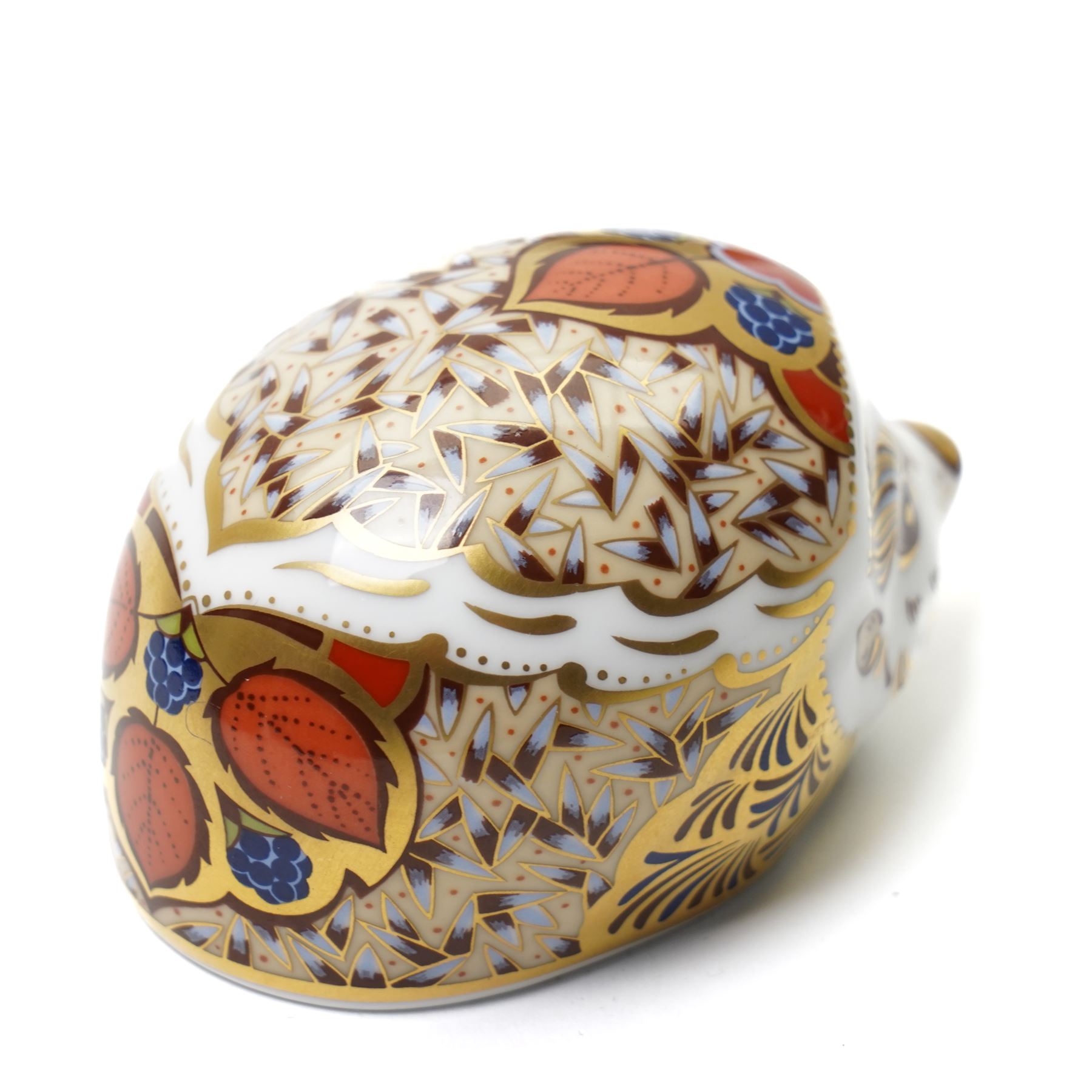 Three Royal Crown Derby paperweights, comprising two of Bramble the Hedgehog, with gold stopper, with boxes, and one of a Woodland Badger, with gold stopper, boxed (3)