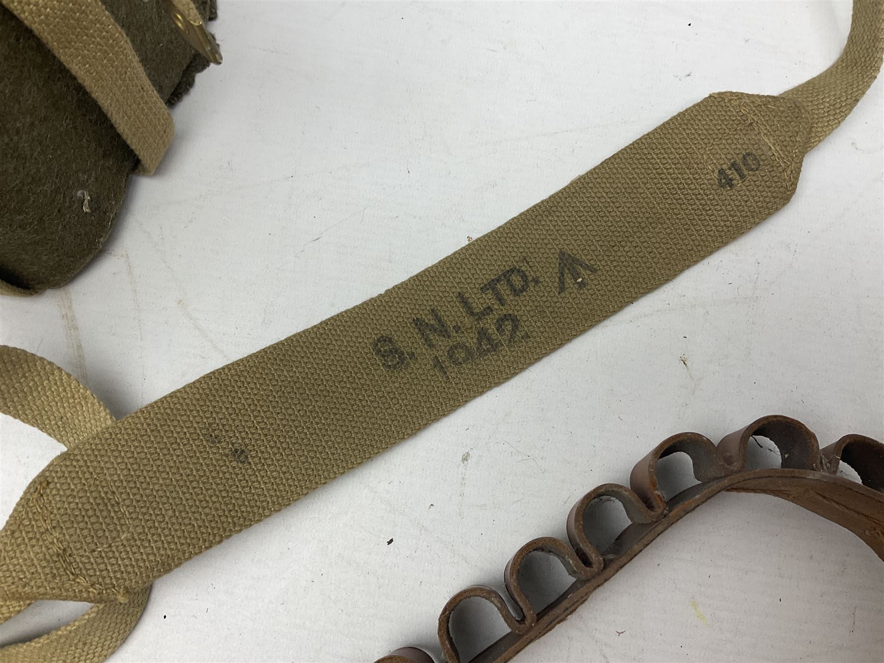 Mundial Brazil bowie knife, the 15.5cm steel blade inscribed 'Sheriff Knife', with banded and aluminium hilt; in leather sheath L29cm overall; British Army felt covered metal water bottle with webbing strap; leather 12-bore cartridge belt; and small pair of non-military binoculars in part case (4)