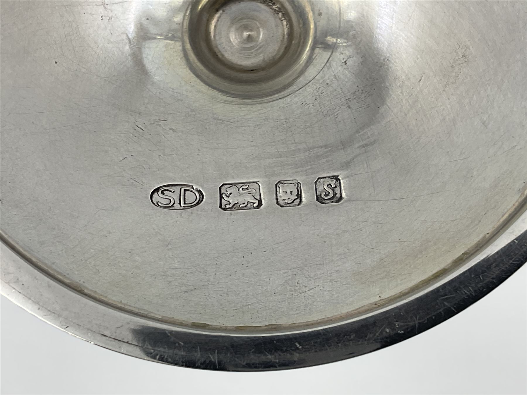 Pair of modern silver candlesticks by Stuart Devlin, the tapering parcel gilt stems with signature textured detailing, each supporting a fluted candle holder and upon a spreading circular foot, hallmarked Stuart Devlin, London 1973, H25cm