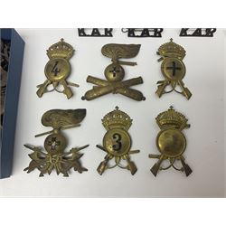 Over thirty British and Continental military metal badges; together with quantity of shoulder titles, collar dogs, rank pips, uniform buttons etc