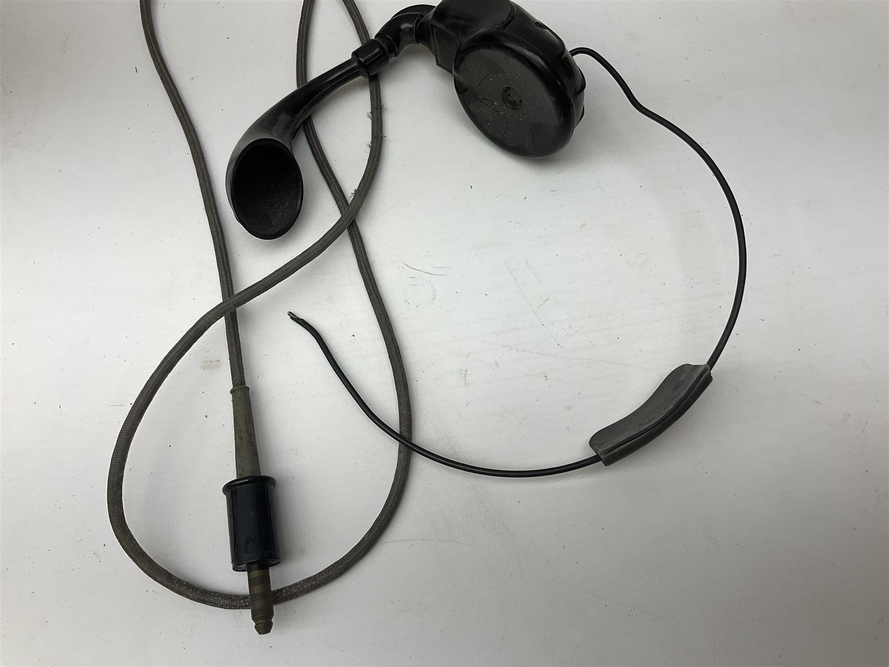 Early-mid 20th century internal telephone system, comprising exchange box with attached TMC rotary telephone and dictograph with Bakelite handset and support upon stained wood case, and 1960s black Bakelite telephone model 312L with G.P.O sticker beneath, largest H30.5cm W36.5cm D30cm