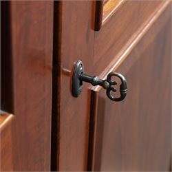 Willis & Gambier - mahogany bedroom wardrobe, projecting cornice with two additional rails, panelled doors with trouser rack and blue baize trinket, enclosing a shelf above a wooden clothes rail and shoe rack, raised on bracket feet 
