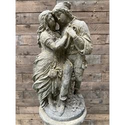 Romeo & Juliet - cast stone garden figure raised on circular fluted column - THIS LOT IS TO BE COLLECTED BY APPOINTMENT FROM DUGGLEBY STORAGE, GREAT HILL, EASTFIELD, SCARBOROUGH, YO11 3TX