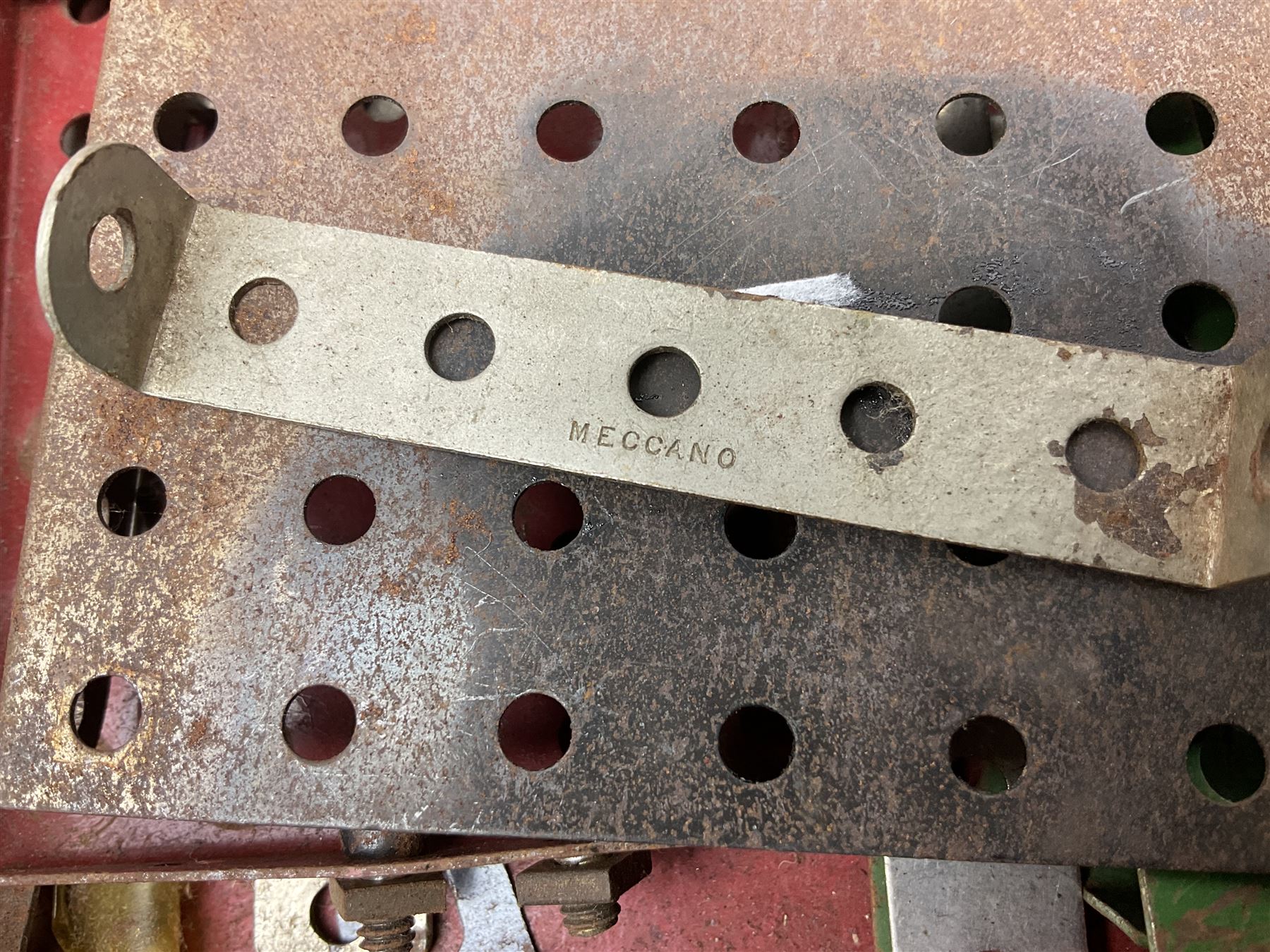 Meccano Set No.5 wooden box containing quantity of predominantly red and green sections, parts, brackets, wheels etc and instruction booklet