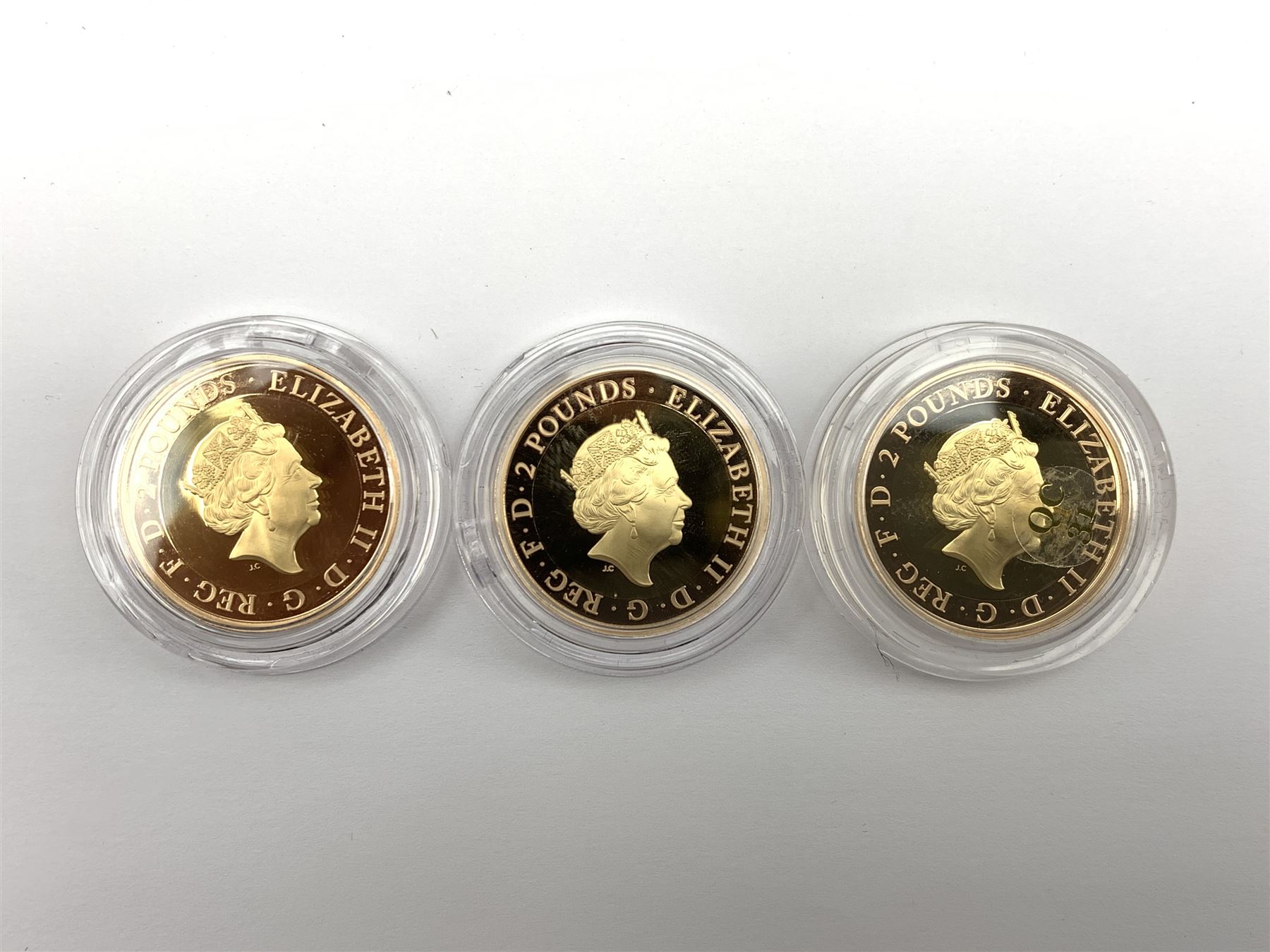 Captain Cook gold proof three coin series, comprising 2018, 2019 and 2020 dated gold proof two pound coins, all three housed together in a Royal Mint presentation box, the individual boxes and certificates are also present