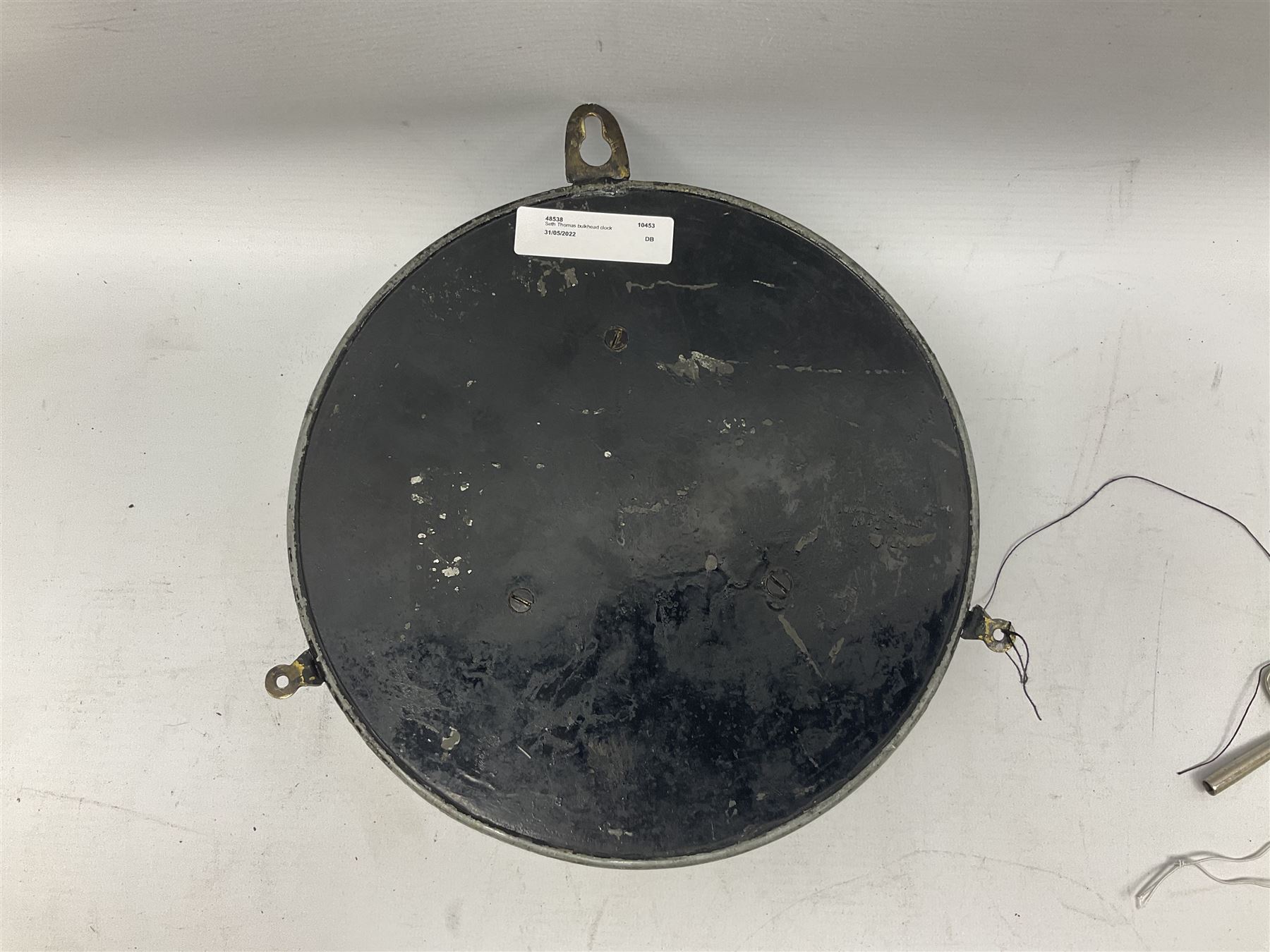 Seth Thomas ship's bulkhead clock with brass bezel and japanned case, the white dial with Roman numerals and subsidiary seconds dial D23.5cm; with key