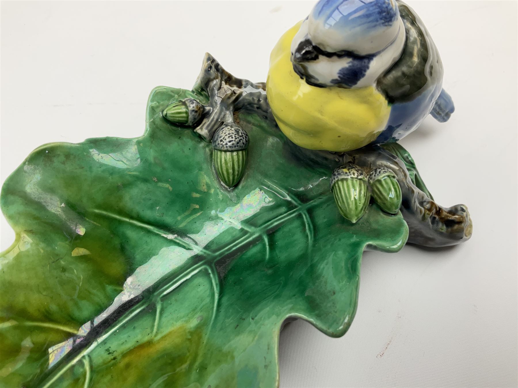 Minton majolica leaf dish, modelled as a Blue Tit perched on a branch with acorns and an oak leaf, date cypher for 1868, impressed marks beneath, L21cm. 