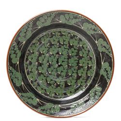 Richard Phethean (1953-): Slipware charger, decorated with green foliage on a black ground, D40cm 