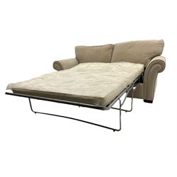 Alstons two seat sofa bed, sprung metal action, upholstered in beige fabric; and matching armchair