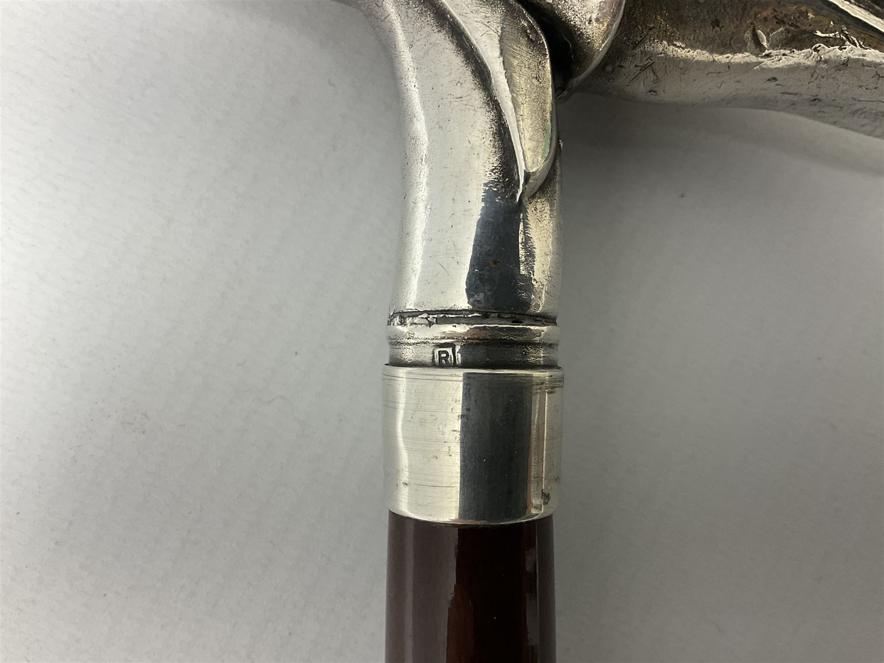 Art Deco style Italian 'Rivestito' covered silver walking stick handle, modelled in the form of a swan, stamped 'R', upon a silver collar hallmarked Birmingham 1986, makers mark DH-L, and hardwood shaft, L96cm

Provenance by vendor repute: 
This walking cane comes from a private collection amassed by the current vendors mother who was an Antique dealer specialising in walking sticks, working at the Portobello Road Antique Market in London for over forty years. 
In 1988 the prop crew from LWT (now ITV) visited Portobello Road looking for, amongst other items, a signature stick for David Suchet to use in his portrayal of Agatha Christie's Poirot. 
At the time this particular walking stick was one of five in possession. The prop crew chose and purchased another of the five which was then used by Suchet throughout all seventy episodes of the much loved series. 
Following the conclusion of the series Suchet was gifted his particular cane, which has been loaned to and can now be seen at the Agatha Christie Gallery at the Torquay Museum. 
