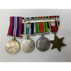Four WWII medals comprising Burma Star, India 1939-45, and two defence medals 1939-1945 together with a Heuer stopwatch and three coins