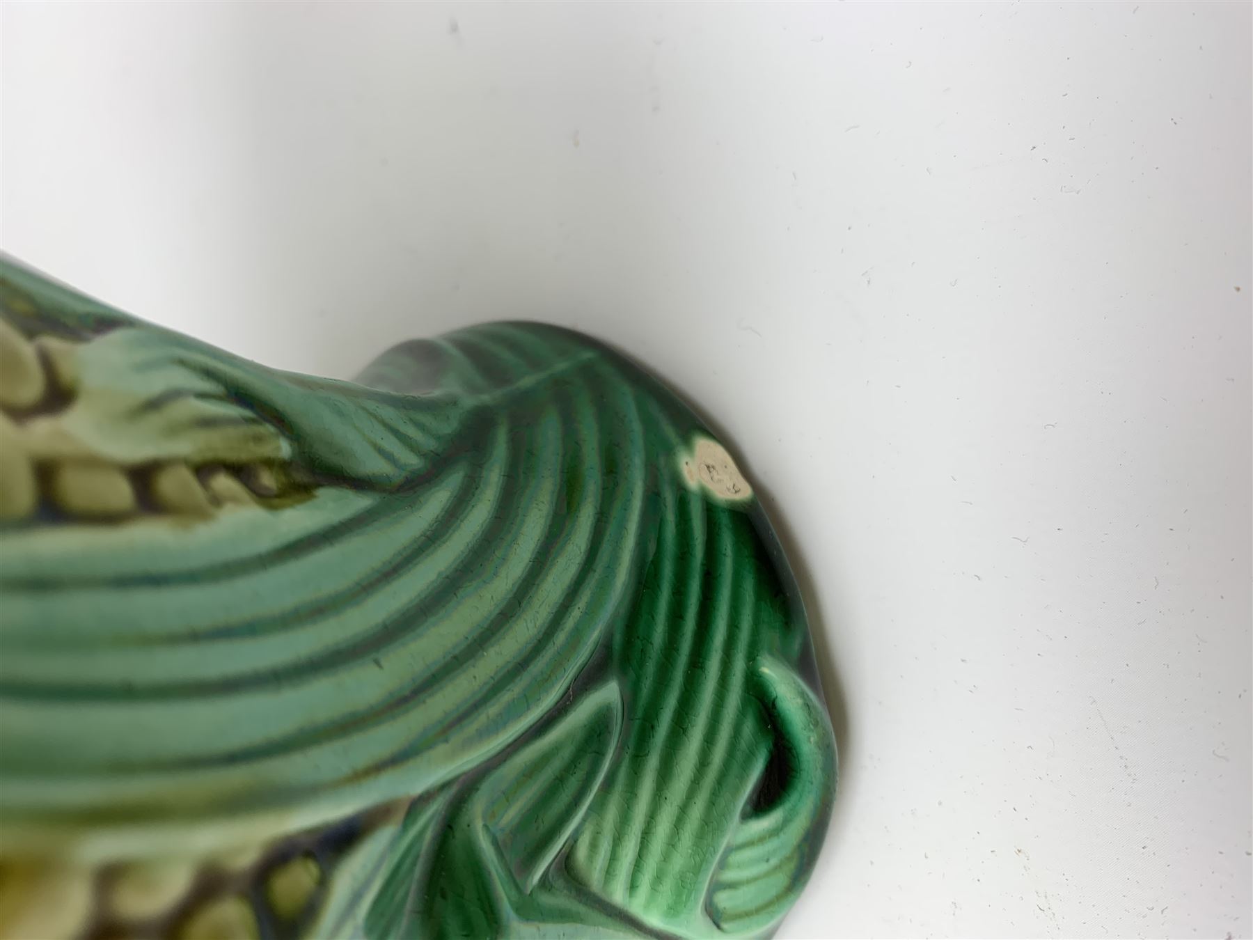 A Victorian majolica bread plate depicting corn within a woven basket, L33cm, together with a Victorian majolica jug modelled in the form of a corn cob, with registration mark beneath, H22cm. 