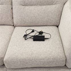 Ashwood - ‘Calypso’ 2-seater motion lounger, upholstered in light stone grey textured fabric with flared arms and split back cushions, fitted with dual electric recline controls, raised on stained tapering legs