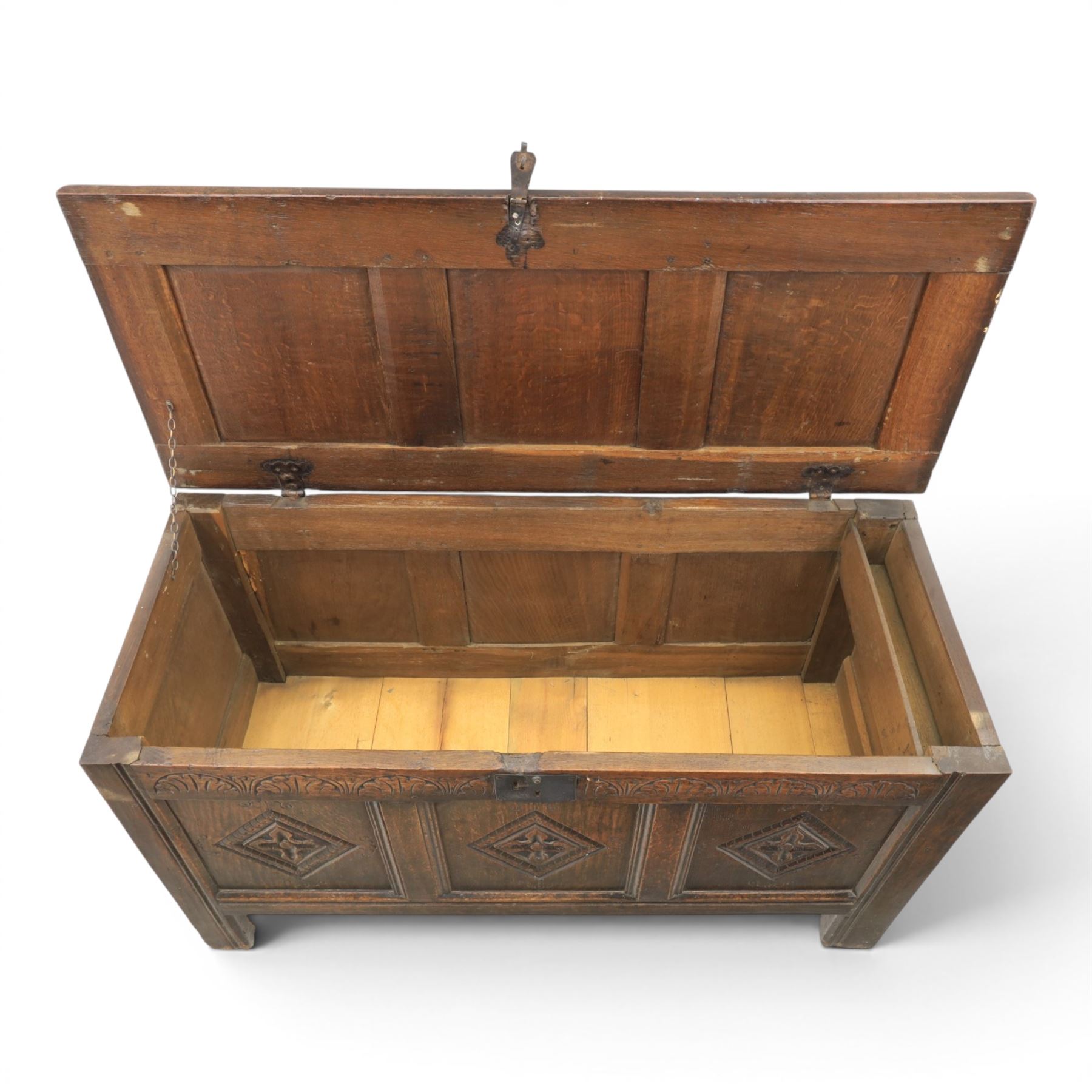 18th century style oak coffer, panelled rectangular top hinged to reveal storage with candle box, carved frieze and front panels, raised on stile feet