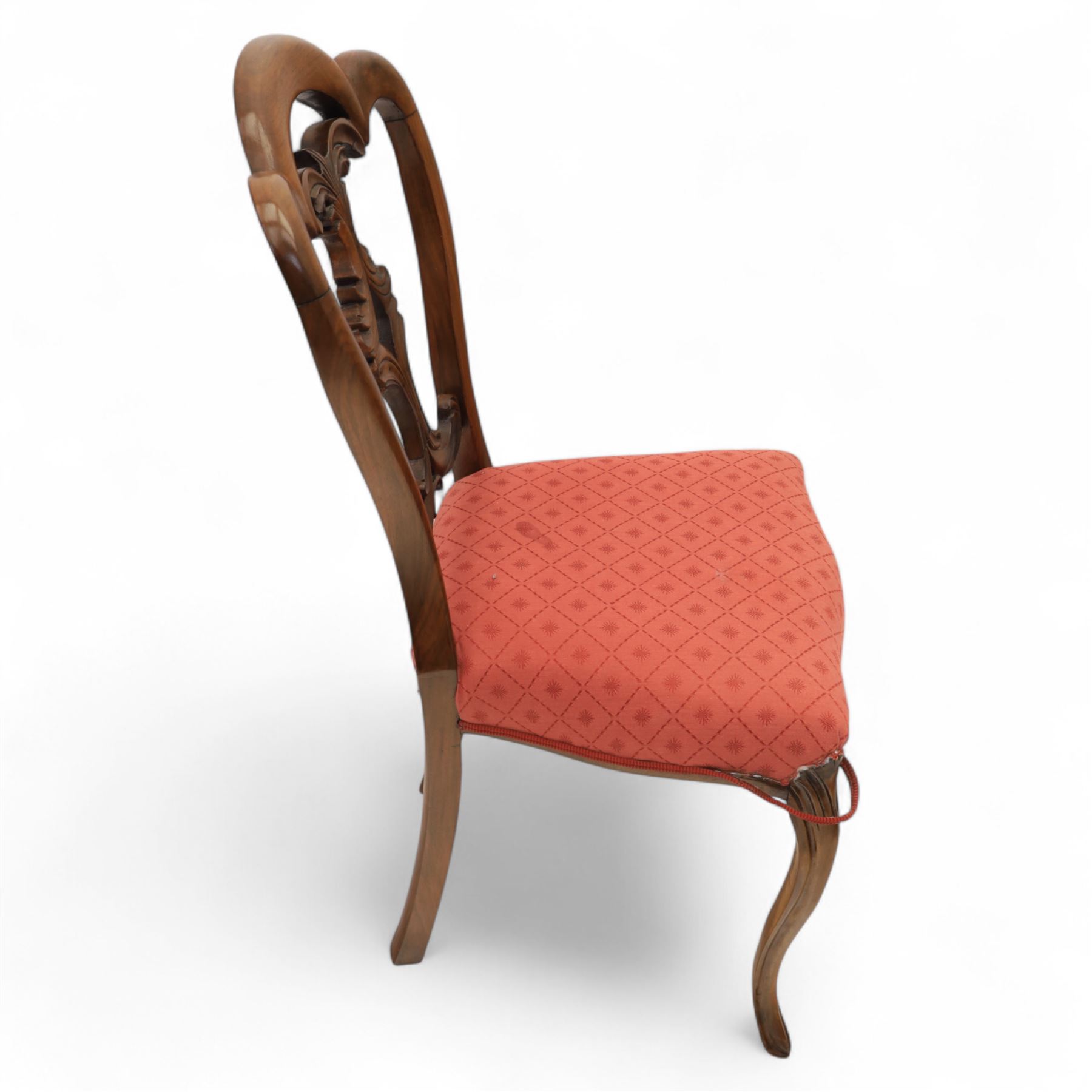 Set of four Victorian walnut balloon back chairs, with a carved and pierced back splat with foliate scrolls, serpentine seat upholstered in a diamond pattern fabric, raised on cabriole legs 