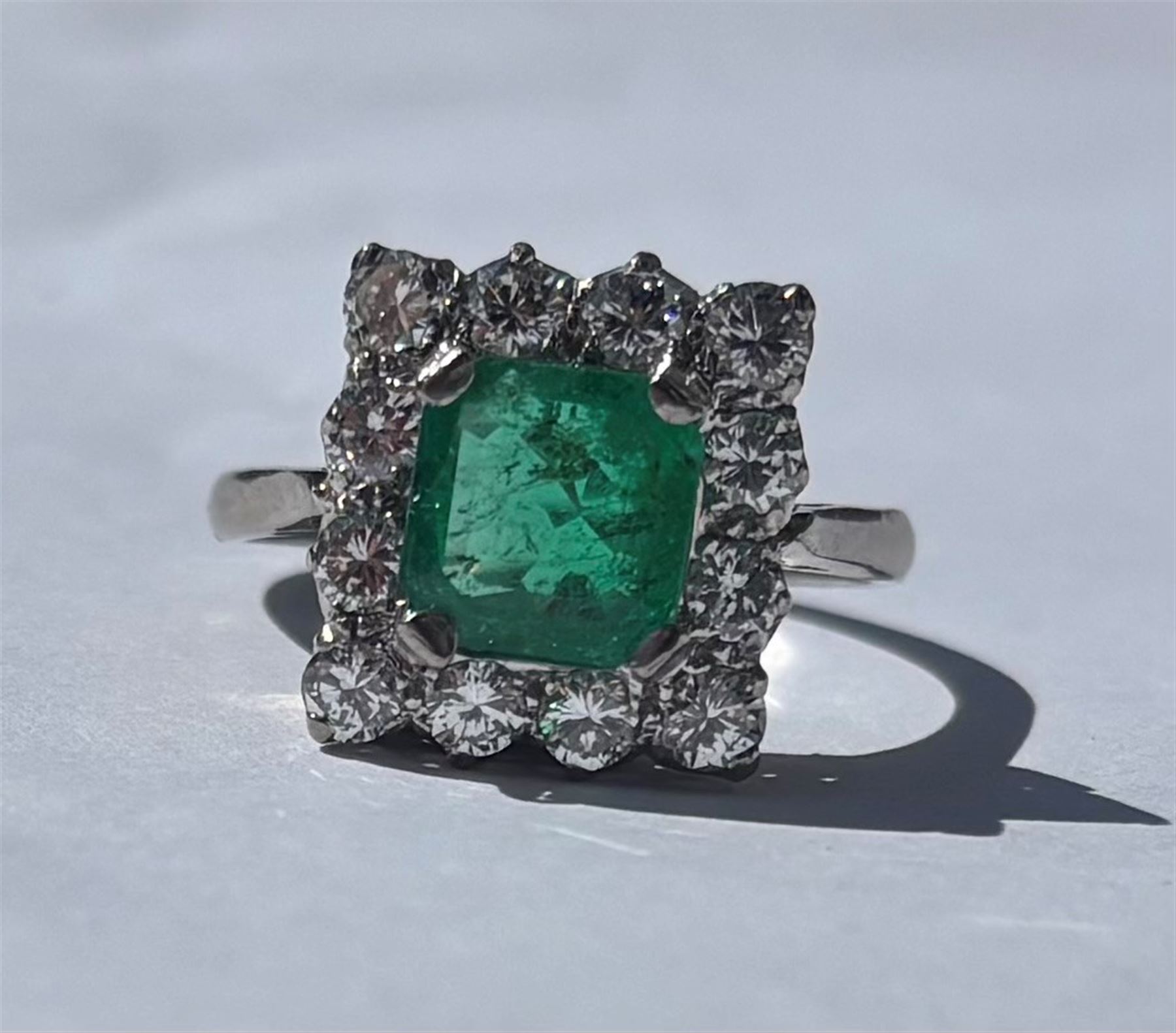18ct white and yellow gold emerald and diamond cluster ring, single octagonal cut emerald of approx 1.55 carat, surrounded by twelve round brilliant cut diamonds, total diamond weight approx 0.95 carat