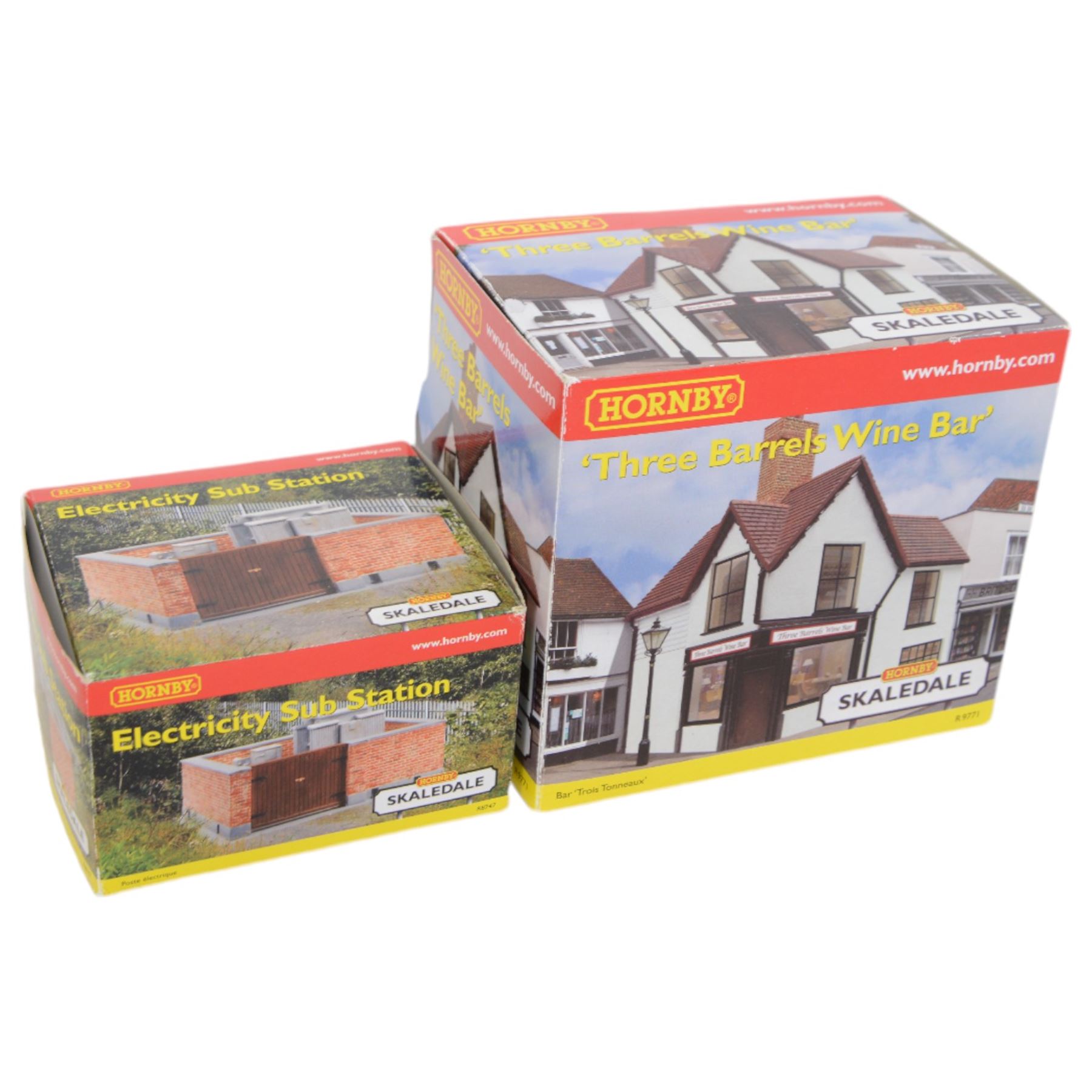 Eleven Hornby '00' gauge Skaledale buildings, comprising R9771 Three Barrels Wine Bar, R8534 Signal Box, R8747 Electricity Sub Station, R8585 Lamp Hut, R8586 Platelayers Hut, R8575 War Memorial, R9828 Bakers Shop, R9767 Andrew James Butchers, R8504 Holly Farm Cottages, R8566 The Boar's Head and R8513 The Vicarige, all boxed