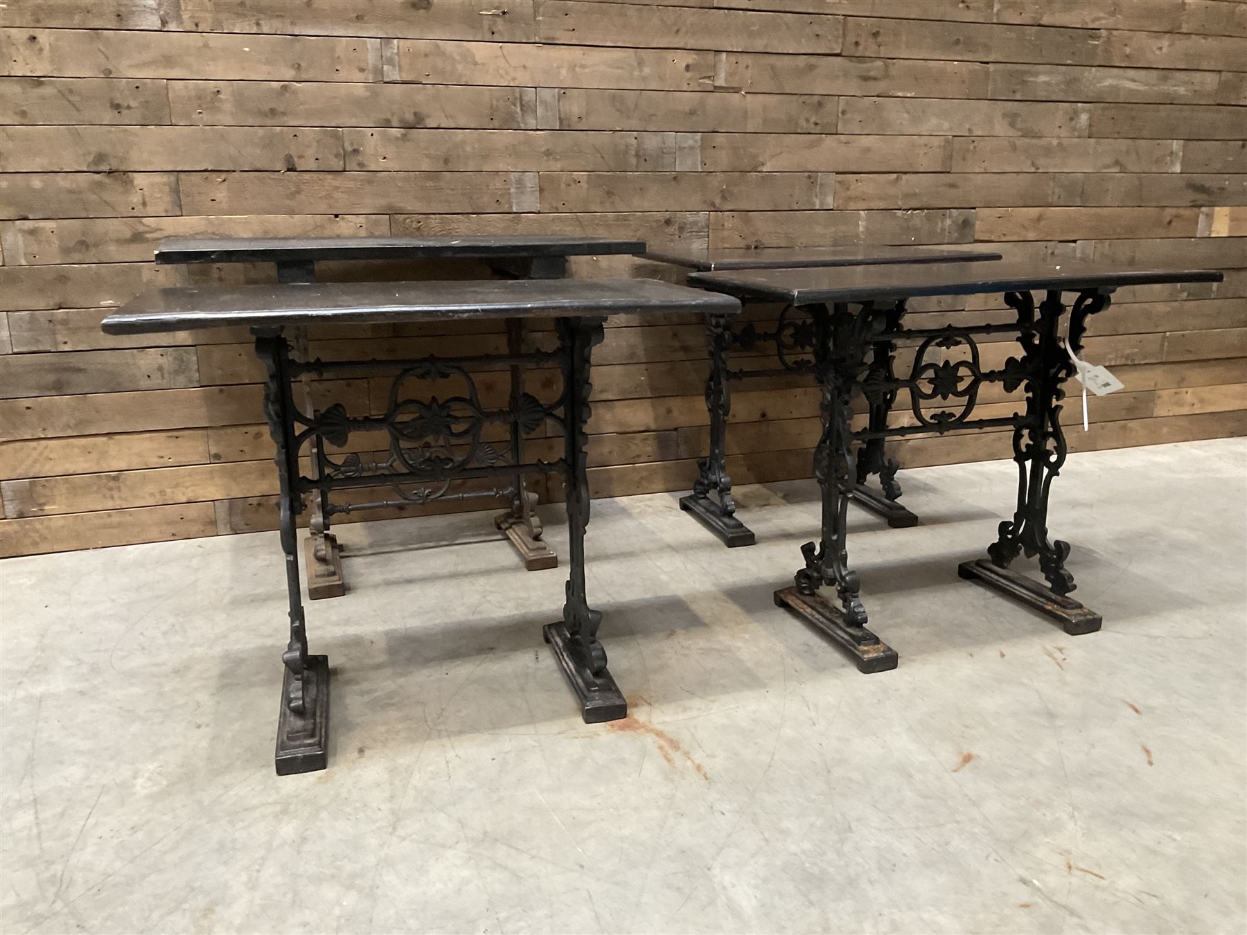 Four cast iron pub or bar tables with rectangular tops
