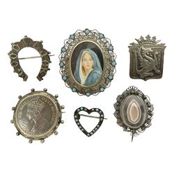 Six Victorian and later silver brooches, including Welsh dragon, horseshoe, religious portrait, coin and heart